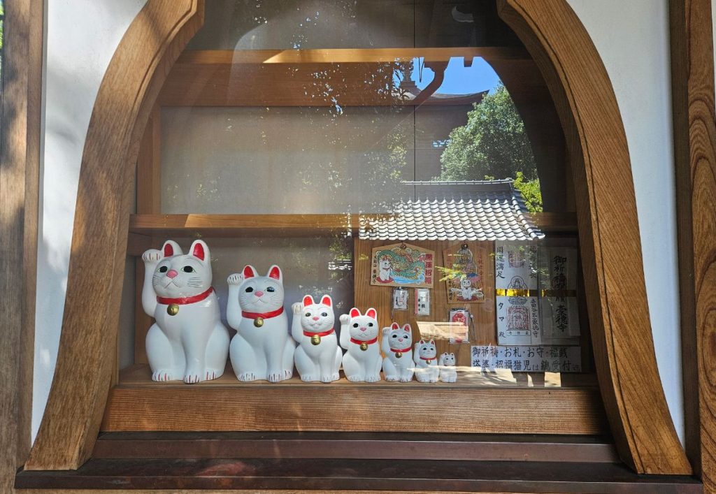 Different sized cat figures on sale at Gotoku-ji (Gotokuji) Temple in Tokyo