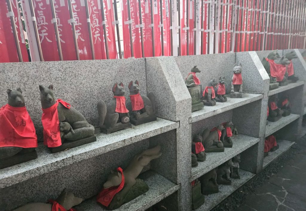 concrete shelves with fox statues of the deity at Toyokawa Inari Shrine in tokyo