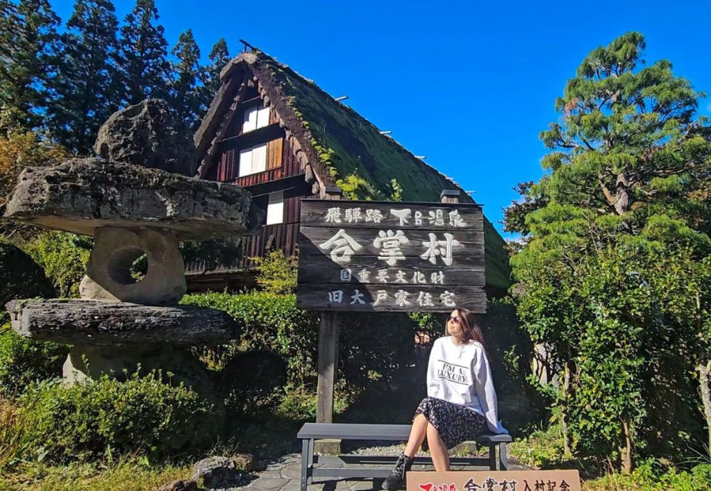 Me sitting in front of the sign at the Gero Historical Village photo spot